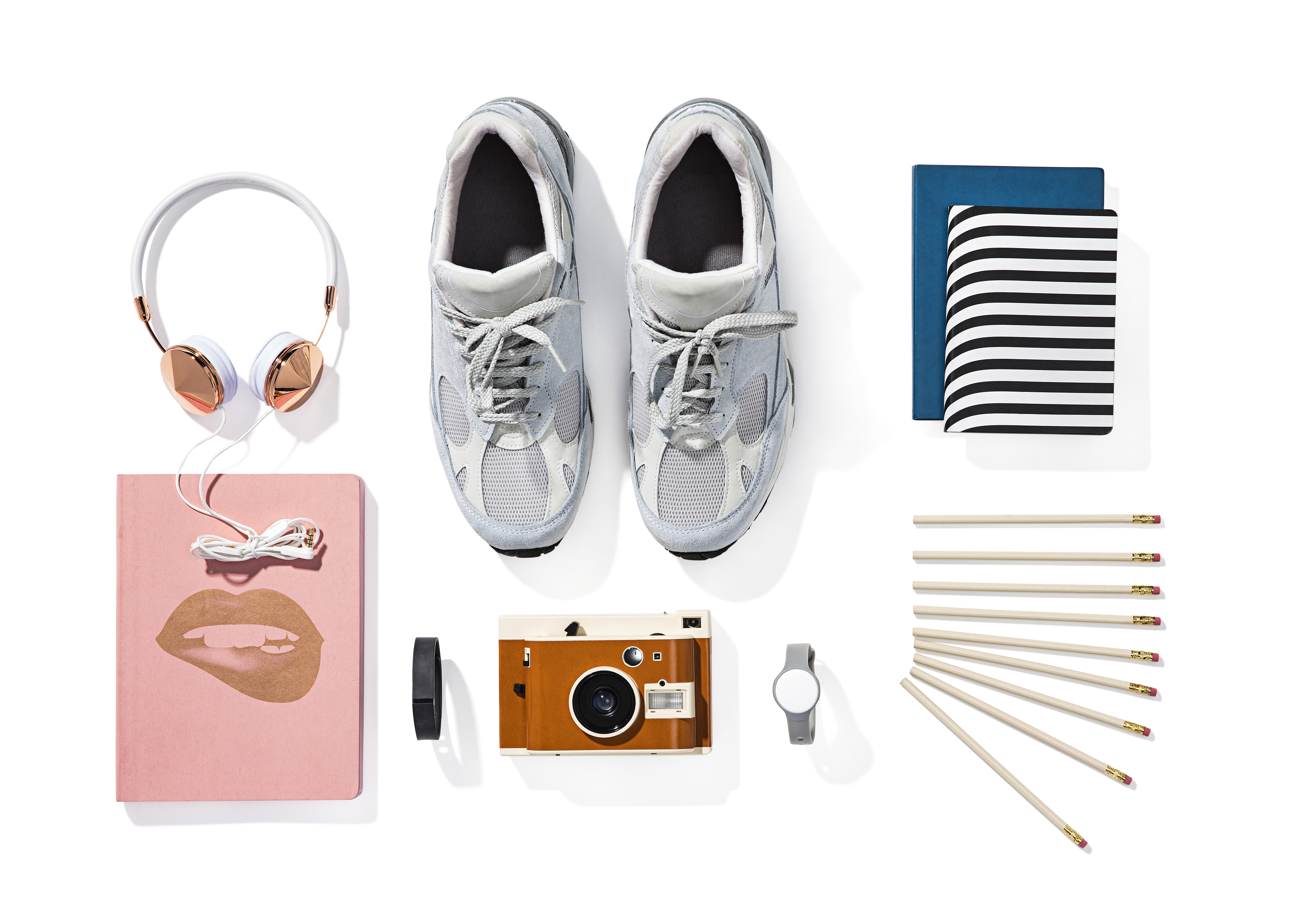 Shoes, notebook, pencils, camera, watch, headphones.