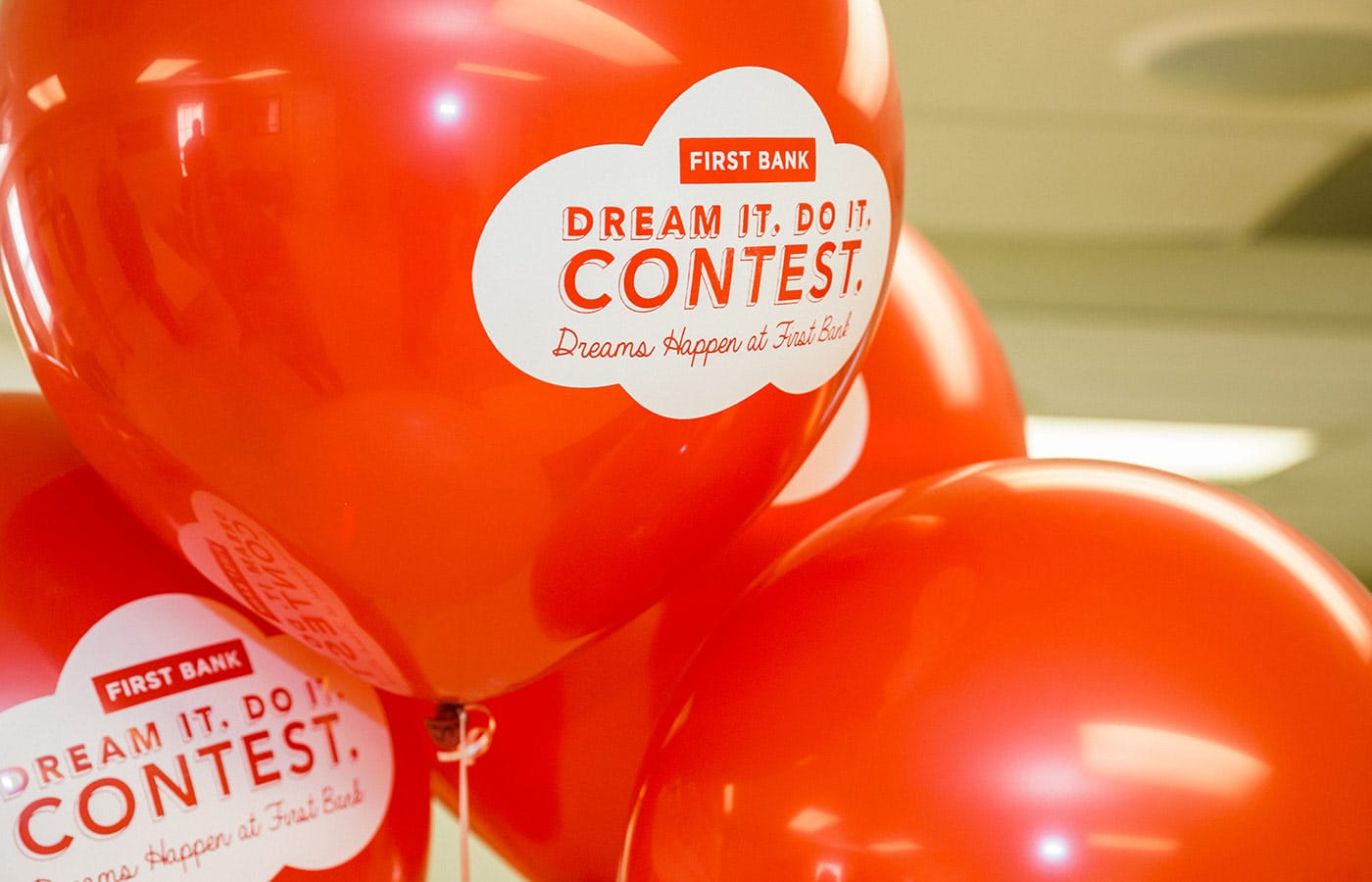 Red balloons with the contest logo on them.