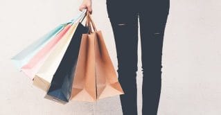 Shopping bags being held by a patron.