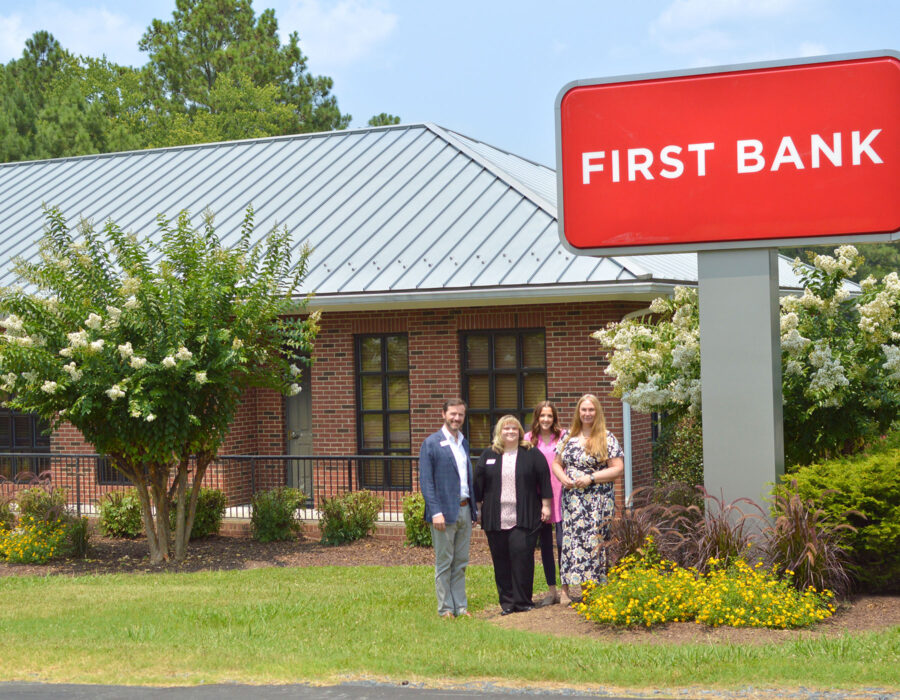 First Bank Bennett Branch exterior with local branch team standing outside.