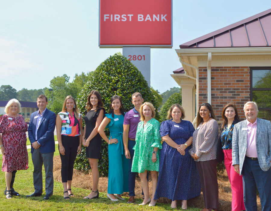 First Bank Lumberton branch team standing outside next to the First Bank sign.