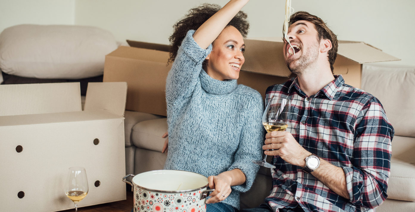 Couple eating noodles with moving items in the background