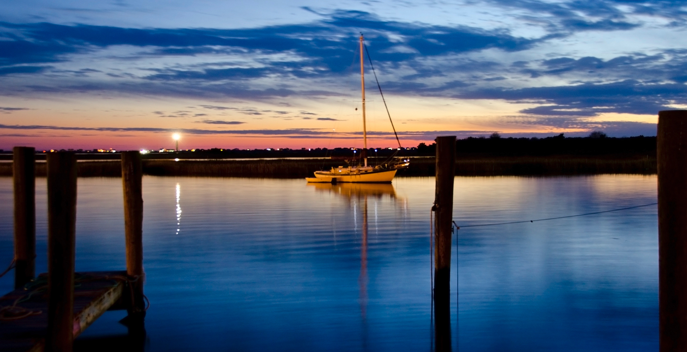 View of boat in water at sunset in Southport, NC