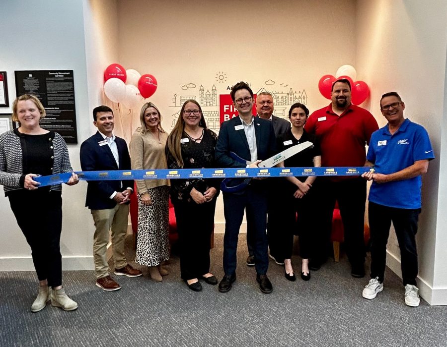 The downtown Asheville team is pictured here doing the location ribbon cutting.