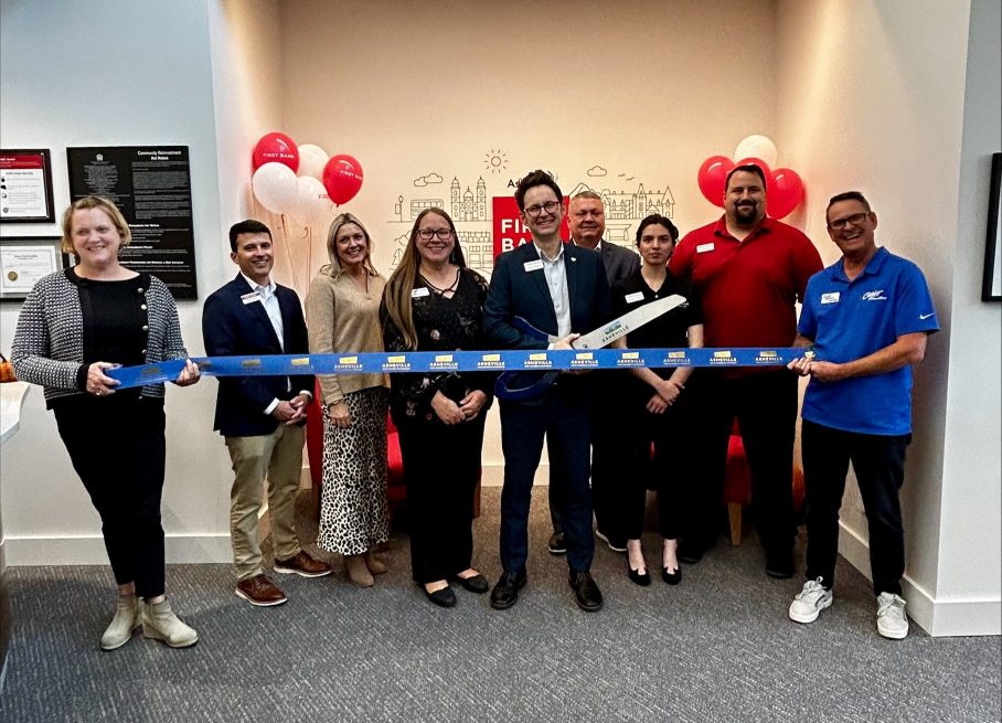 The downtown Asheville team is pictured here doing the location ribbon cutting.
