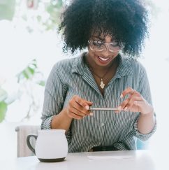 Woman taking picture of check with phone