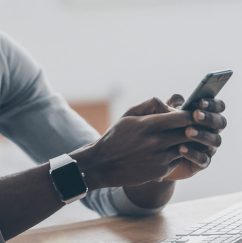 Male texting on an iPhone