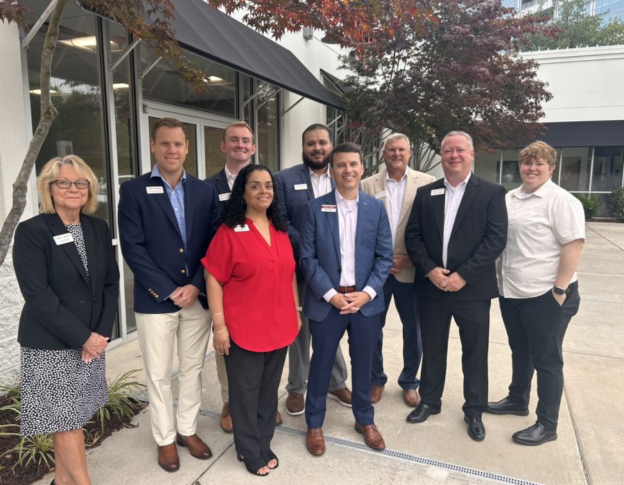The Charlotte Ballantyne team poses outside of the new First Bank branch on North Community House Road.