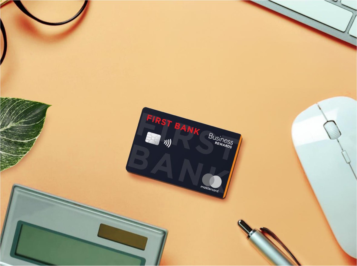 First Bank's Mastercard Business Card with Rewards sitting on a desk.