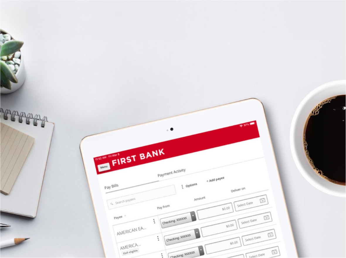 Tablet with the First Bank digital banking app open.