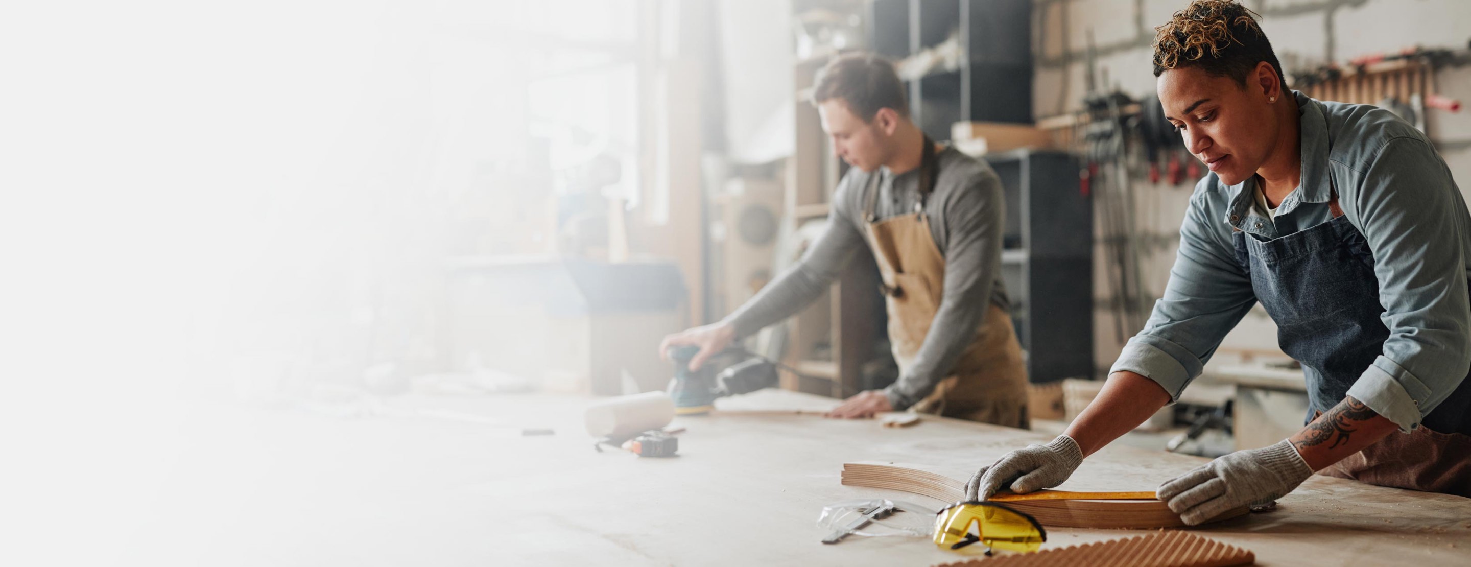 Woodworkers working in workshop.