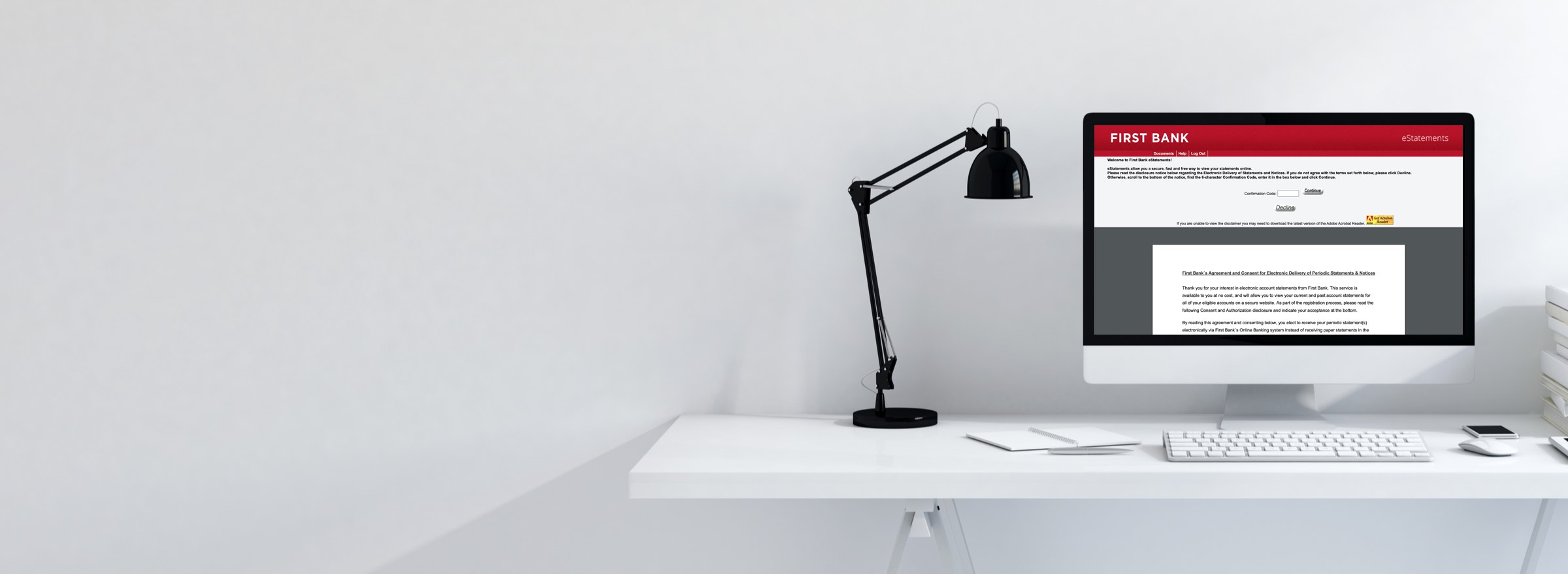 Lamp and computer with online banking screen on top of desk