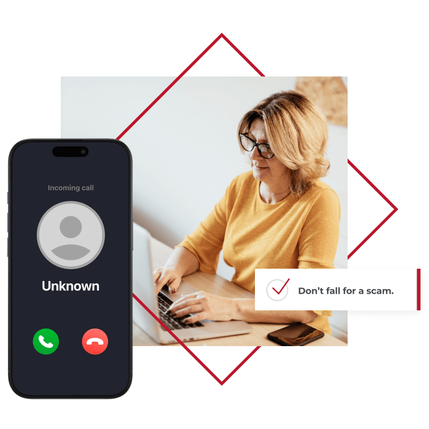 A phone with an unknown call and a woman typing on a laptop